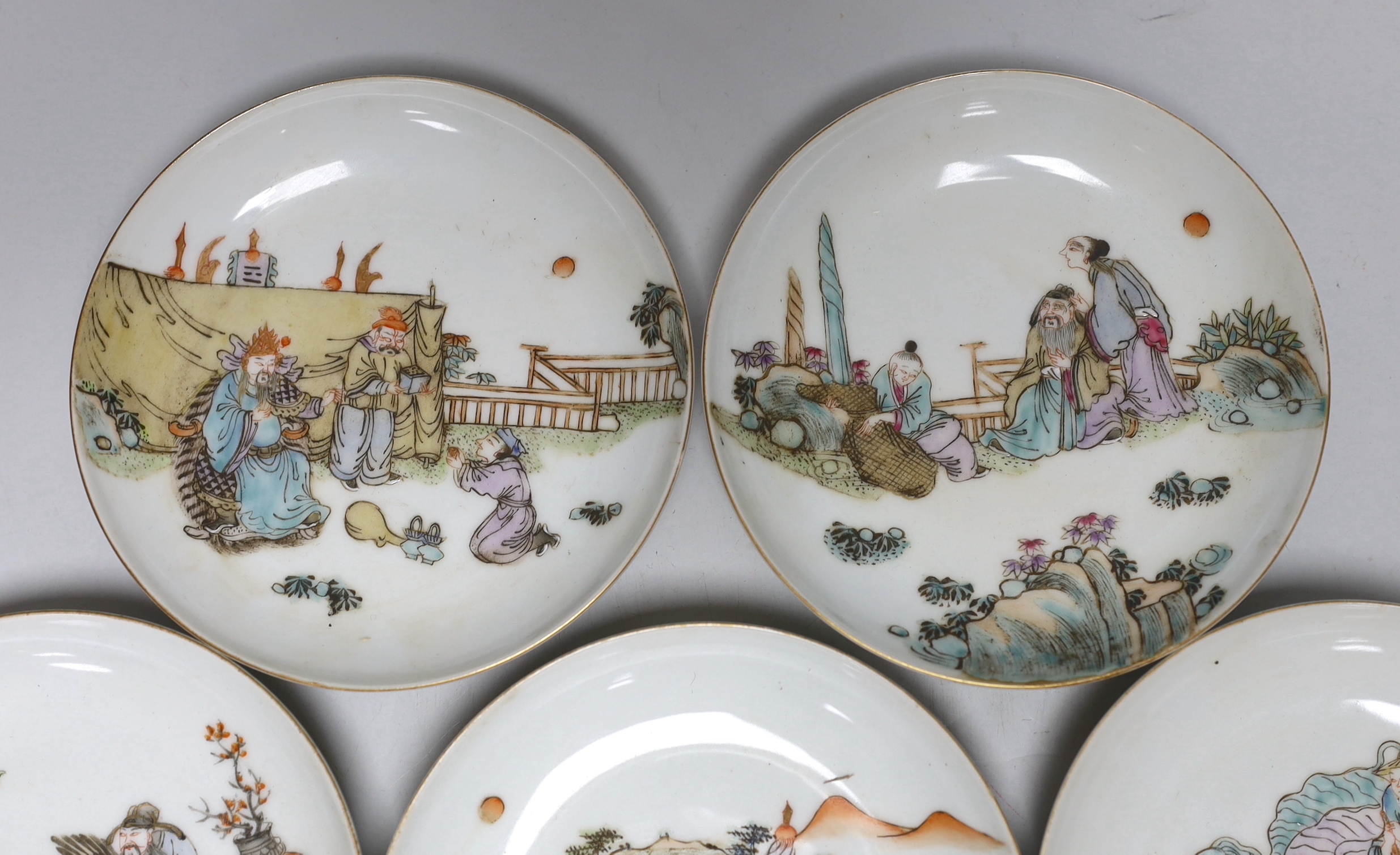 A set of five Chinese enamelled porcelain saucer dishes, decorated with figures and elders, each 13cm in diameter